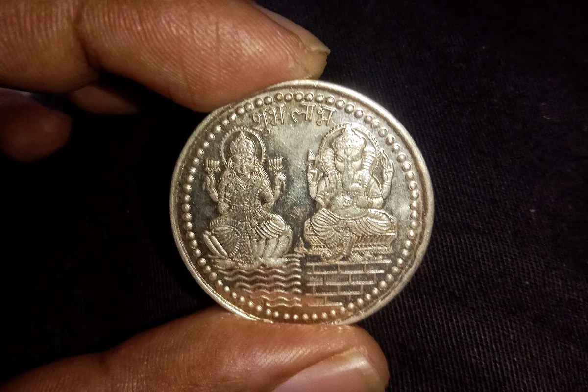 A silver coin bearing Lakshmi and Ganesha (representative)