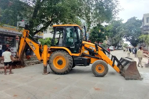 Representative photo: a JCB machine at work by a road