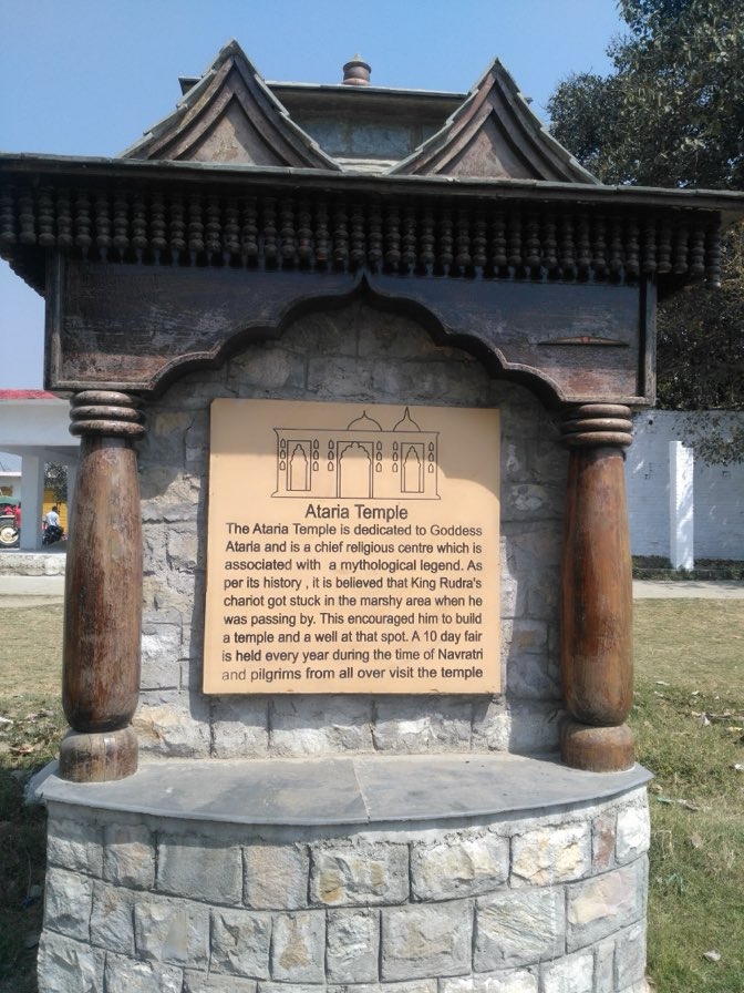 The stone and timber information plaque in the grounds of Atariya temple, Rudrapur, describing its history.